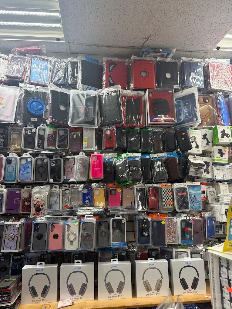 Wall of phone cases and headphones at Maxworld Tech Store, Yonkers