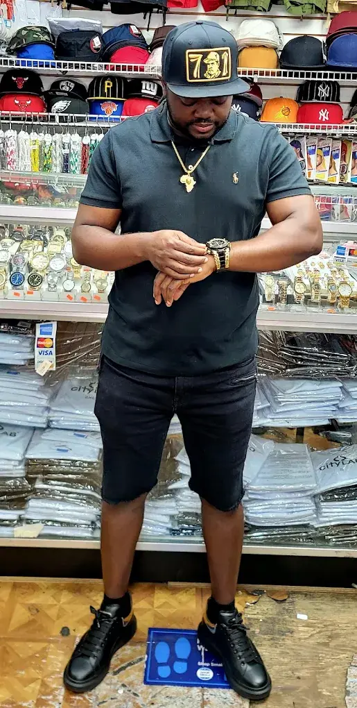 Watches and fitted caps on display