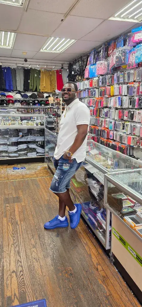 Customer in Maxworld Tech Store next to the phone accessories wall